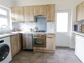 A kitchen with appliances and cabinets at No.1 Vanderhoof Way Saundersfoot