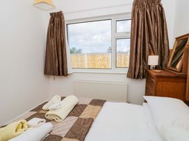 A bedroom with a bed and window at No.1 Vanderhoof Way Saundersfoot
