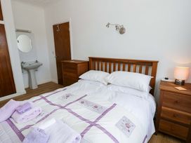 A bedroom with a bed and a mirror at No.1 Vanderhoof Way in Saundersfoot