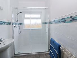 A bathroom with a shower and sink at No.1 Vanderhoof Way Saundersfoot