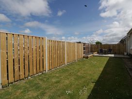 A garden area with fencing and patio furniture at No.1 Vanderhoof Way Saundersfoot