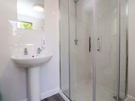 A bathroom with a washbasin and shower at Shepherds Hut 1