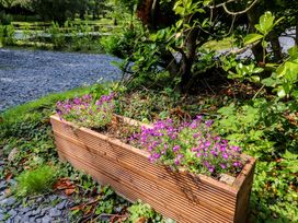 A planter with flowers in a garden at Shepherds Hut 1