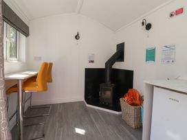 A dining area with table and chairs at Butterfly Hut 1 Forton near Garstang