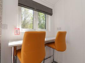 An office area with two orange chairs and a table near a window at Butterfly Hut 1 Forton near Garstang