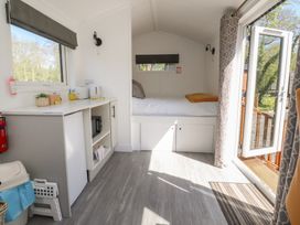 A bedroom with a bed and kitchenette area at Butterfly Hut 1 Forton near Garstang