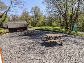 An outdoor area with picnic tables and a wooden structure at Butterfly Hut 1 Forton near Garstang