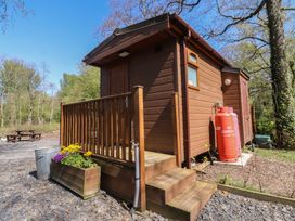 A cabin with steps and a planter at Butterfly Hut 1 Forton near Garstang