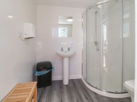 A bathroom with shower and sink at Butterfly Hut 1 Forton near Garstang