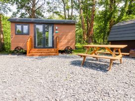 A hut with steps and a picnic table in an outdoor area at Shepherds Hut 2