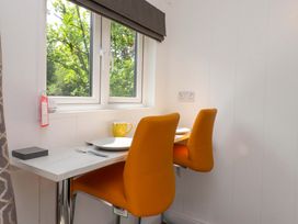 A dining area with two chairs and a table at Shepherds Hut 2 