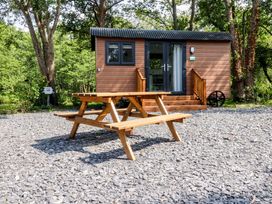 A cabin with a bench in the outdoor area at Shepherds Hut 2 