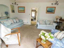 A living room with sofas and a coffee table at Trwst Y Don in Rhosneigr