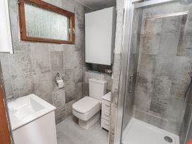 A bathroom with toilet and shower at Farnes Lodge Longframlington