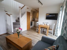 A living room with a dining area and kitchen at The Annex next to St Johns Southwold