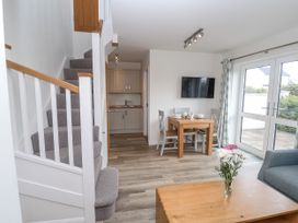 A living room with a dining table and chairs at The Annex next to St Johns Southwold