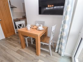 A dining area with a table and chairs at The Annex next to St Johns Southwold