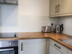 A kitchen with an oven, kettle, toaster, and sink at The Annex next to St Johns Southwold