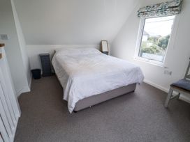A bedroom with a bed and nightstand at The Annex next to St Johns in Southwold