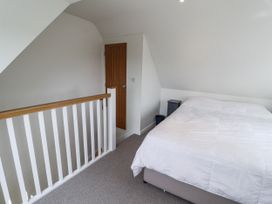 A bedroom with a bed and nightstand at The Annex next to St Johns in Southwold