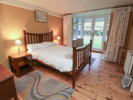 A bedroom with a bed and nightstand at The Anchorage