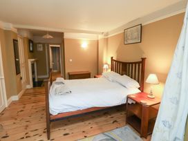 A bedroom with a bed and nightstand at The Anchorage in 