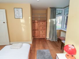 A bedroom with a bed and wardrobe at The Anchorage