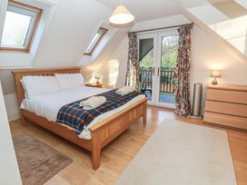 A bedroom with a bed and dresser at The Anchorage in 