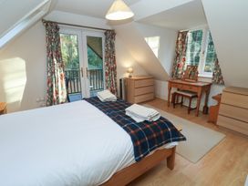 A bedroom with a bed and dressers at The Anchorage in 