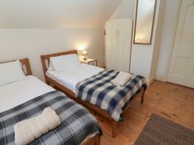 A bedroom with two beds and a wardrobe at The Anchorage in 