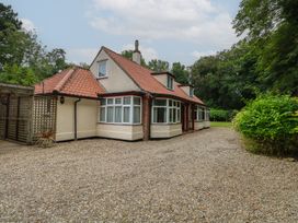 A house with a driveway and garden at The Anchorage in Hoveton & Wroxham