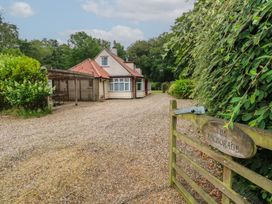 A house with a gravel driveway and gate at The Anchorage in Hoveton & Wroxham