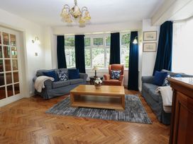 A living room with couches, a coffee table, and a window at The Anchorage in Hoveton & Wroxham