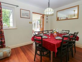 A dining room with a table set for meals at The Anchorage in Hoveton & Wroxham