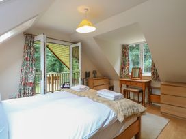 A bedroom with a bed and a dresser at The Anchorage Hoveton & Wroxham