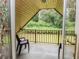 A balcony with a chair and railings at The Anchorage in Hoveton & Wroxham