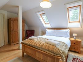 A bedroom with a bed and wardrobe at The Anchorage in Hoveton & Wroxham