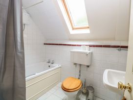 A bathroom with a bath tub and toilet at The Anchorage in Hoveton & Wroxham