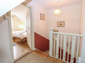 A hallway with a staircase and a door at The Anchorage in Hoveton & Wroxham
