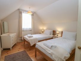 A bedroom with two single beds and a dresser at The Anchorage in Hoveton & Wroxham