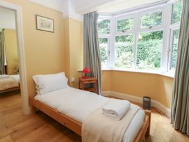 A bedroom with a single bed and window at The Anchorage in Hoveton & Wroxham