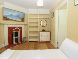 A bedroom with a bed and fireplace at The Anchorage in Hoveton & Wroxham