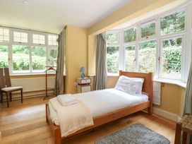 A bedroom with a single bed and windows at The Anchorage in Hoveton & Wroxham