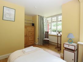 A bedroom with a bed and wardrobe at The Anchorage in Hoveton & Wroxham