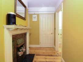 A hallway with a mirror and heater at The Anchorage in Hoveton & Wroxham
