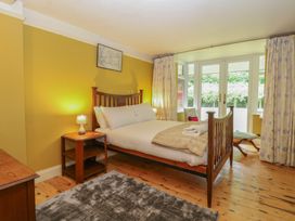 A bedroom with a bed and nightstand at The Anchorage in Hoveton & Wroxham
