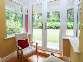 A conservatory with a view of the garden at The Anchorage in Hoveton & Wroxham