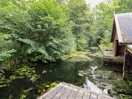 A water view with plants and a wooden dock at The Anchorage in Hoveton & Wroxham