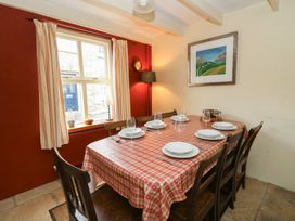 A dining room with a table set for dinner at St John's House in Newport, Pembrokeshire