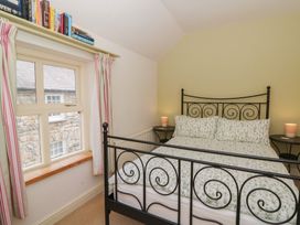 A bedroom with a bed and window at St John's House in Newport, Pembrokeshire